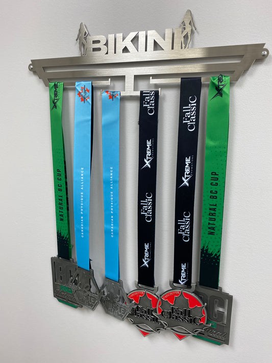medal hanger for medallions, it reads Bikini across the top with a bikini competitor posing on either side. and has 4 bars that you can hang the lanyards off of that will display the medals. You will mount this to a wall with the screw kit provided.  comes in black and silver